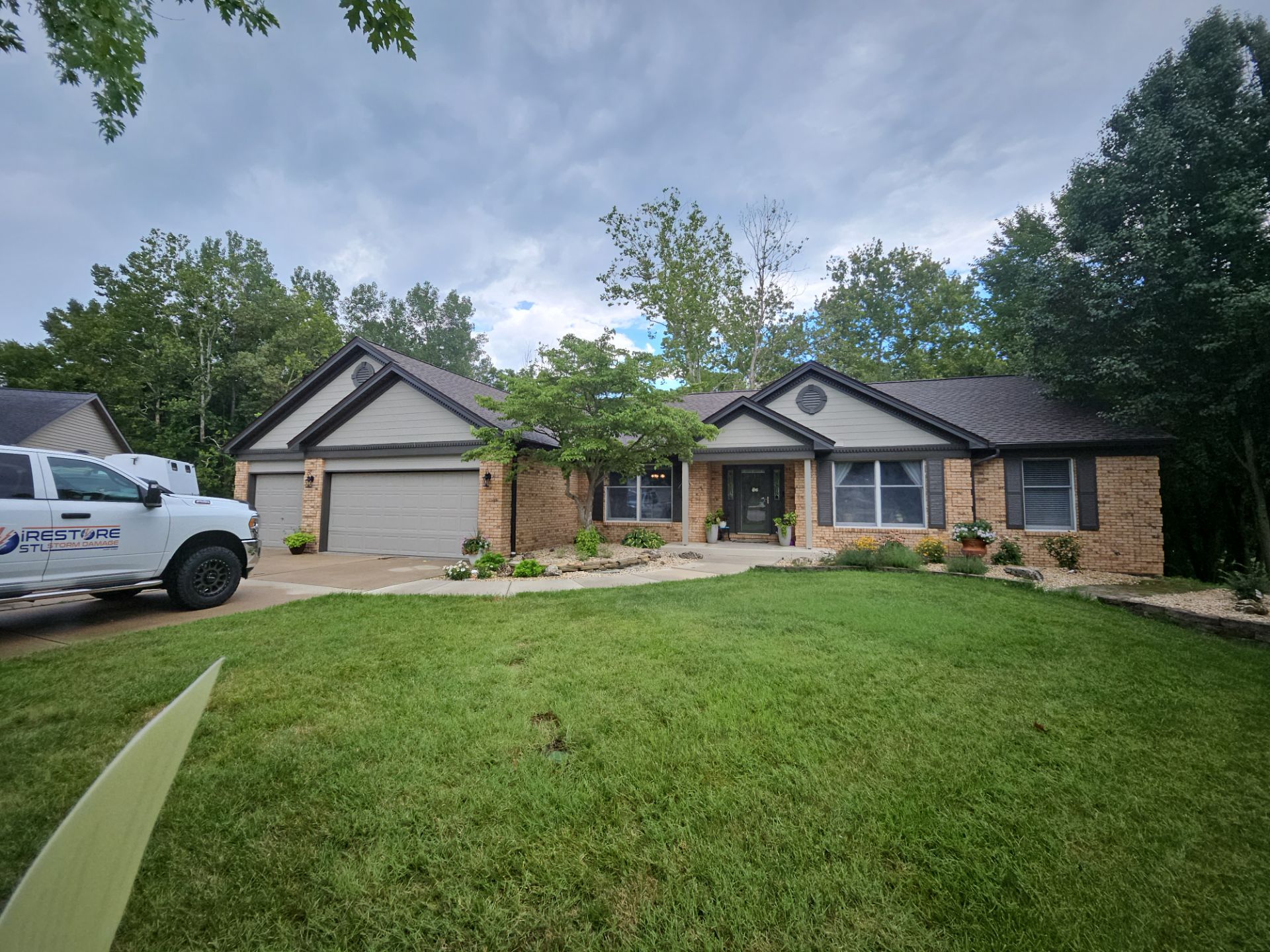 Completed dark architectural shingle roof on a single-story brick ranch home with twin front gables in Collinsville, IL