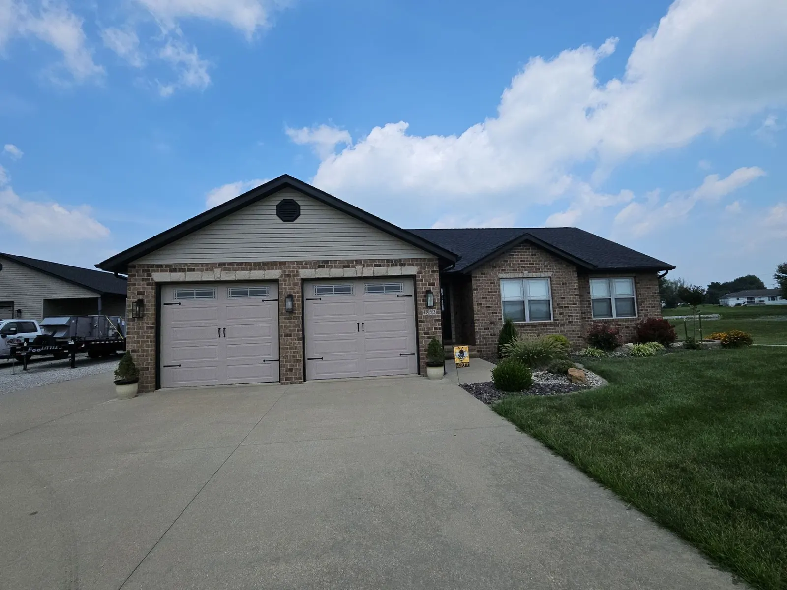 Finished architectural shingle roof on a brick and tan-sided ranch home with a two-car garage in Aviston, IL