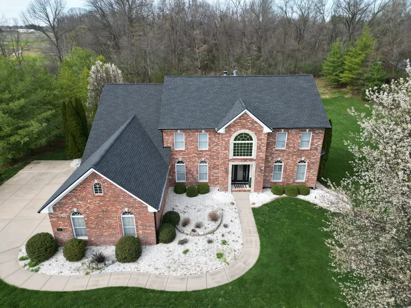 Drone view of a finished architectural shingle roof on a brick two-story home in the Belleville, IL area
