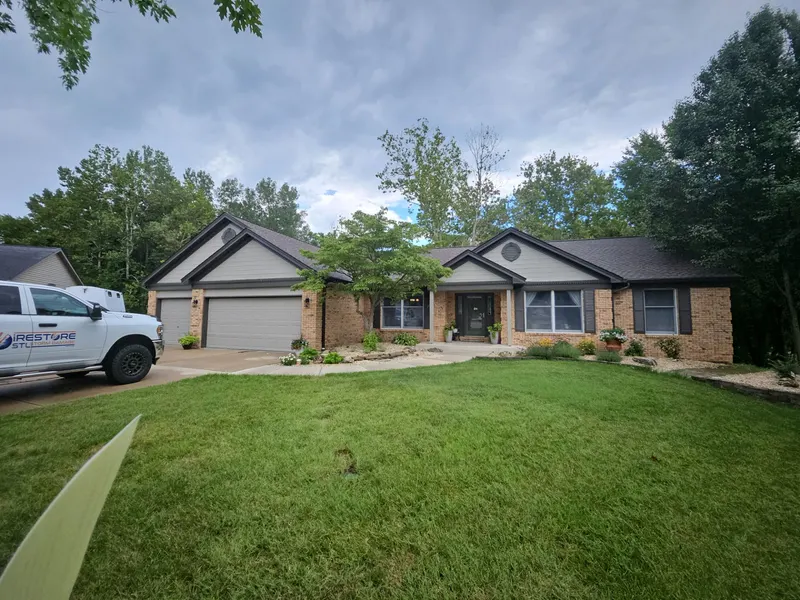 Completed dark architectural shingle roof on a single-story brick ranch home with twin front gables in Collinsville, IL