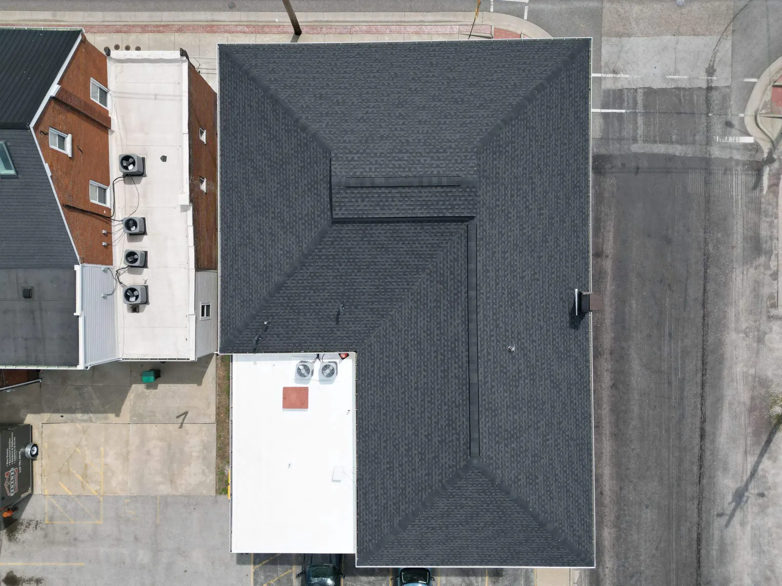 Aerial view of a large shingle roof on a commercial building in Millstadt, IL