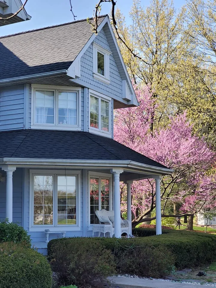Blue siding, white trim and a new roof on a Victorian-style home in the Metro East